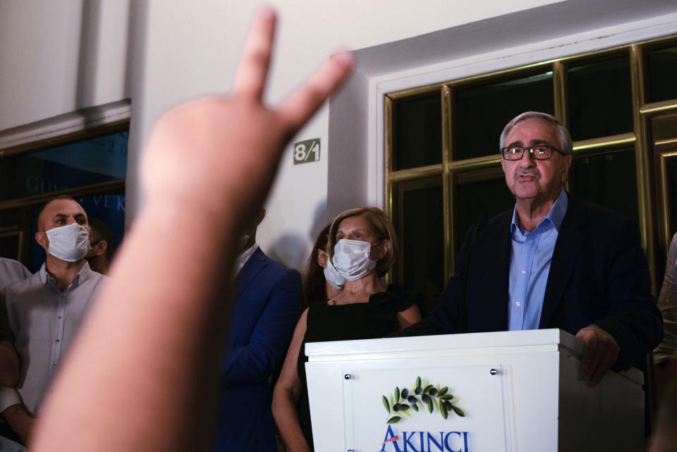 In this photo taken on Sunday, Oct. 11, 2020, Turkish Cypriot leader and candidate Mustafa Akinci addresses to his supporters after reaching the second round of the Turkish Cypriots election for a new leader in the Turkish occupied area in the north part of the divided capital Nicosia, Cyprus. Turkish Cypriots vote on Sunday Oct. 18, 2020 in a leadership runoff that could decide if they want to retain more control over their own affairs or steer even closer to an increasingly domineering Turkey. (AP Photo/Nedim Enginsoy)