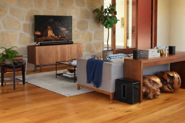 The Sonos Arc, Sub, and One SL speakers set up in a living room.