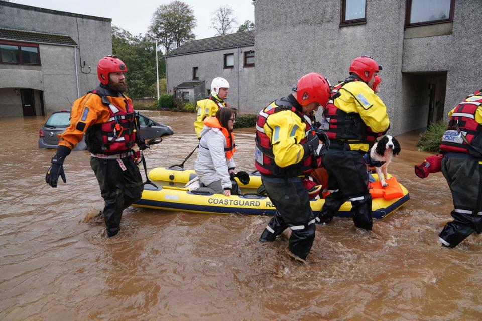 Members of the emergency services help local residents to safety in Brechin, Angus (PA Wire)