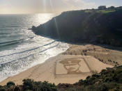 <p>People on Porthcurno beach, Cornwall, walk past a large scale sand portrait of Lieutenant Richard Charles Graves-Sawle, who was 26 when he was killed by a sniperâ’s bullet near Ypres on November 2 1914. (Getty) </p>