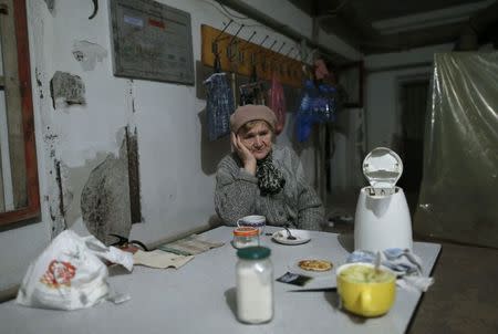 A refugee sits in a shelter in the north part of Donetsk, near the airport November 20, 2014. REUTERS/Antonio Bronic