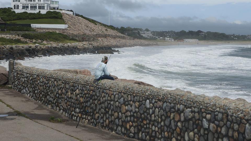 westerly, ri august 22 a man fishes at the watch hill lighthouse for stripped bass with home of taylor swift in the background during the eye of the tropical storm henri in westerly, ri on aug 22, 2021 photo by matthew j leethe boston globe via getty images