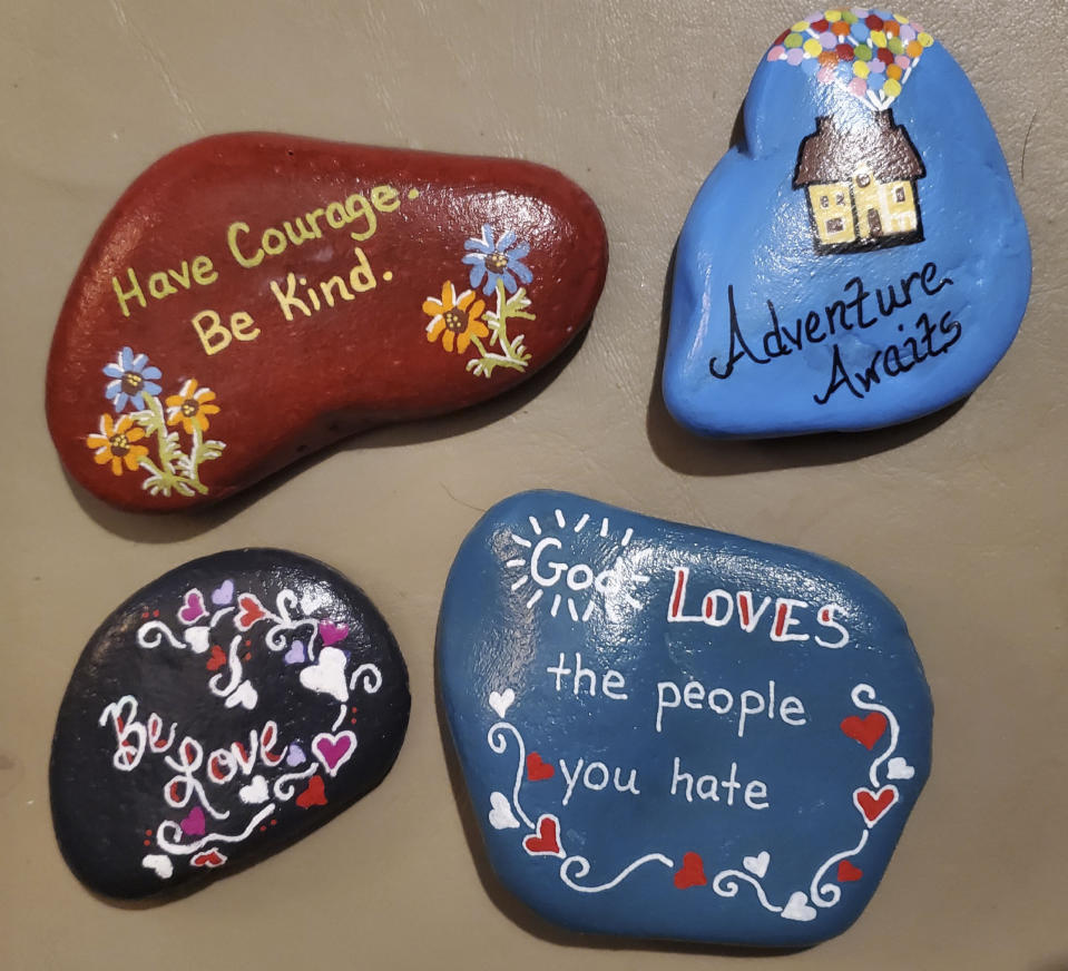 In this Oct. 2020 photo provided by Debra Ferrell, words of encouragement are painted on rocks in Roanoke, Va. For her 53rd birthday this year, Ferrell decided to give back with 53 acts of kindness for people across the country. (Debra DC Ferrell via AP)