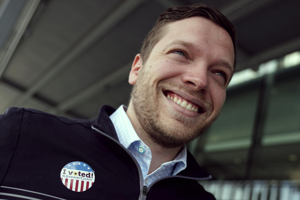 Tony Bergida smiles after voting early at a polling place, Thursday, Oct. 27, 2022, in Olathe, Kan. Bergida, a 27-year-old father of two and the chair of the Kansas Young Republicans, said the top issue on his mind as he cast his ballot was the economy. (AP Photo/Charlie Riedel)