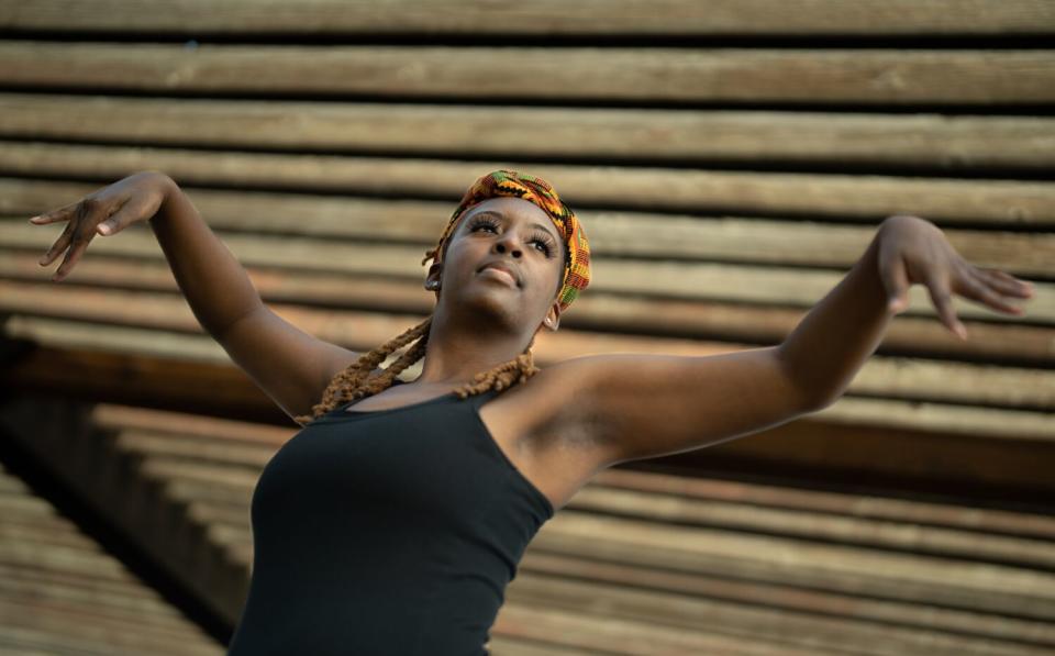 A dancer practices in a field at the Colonel Allensworth State Historic Park.