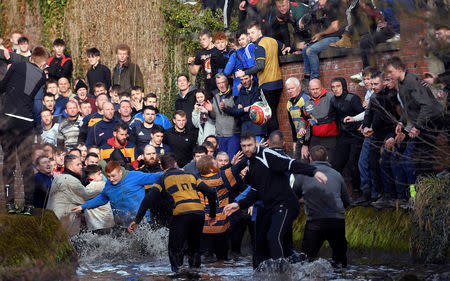 Players fight for the ball during the annual Shrovetide football match in Ashbourne, Britain March 5, 2019. REUTERS/Toby Melville