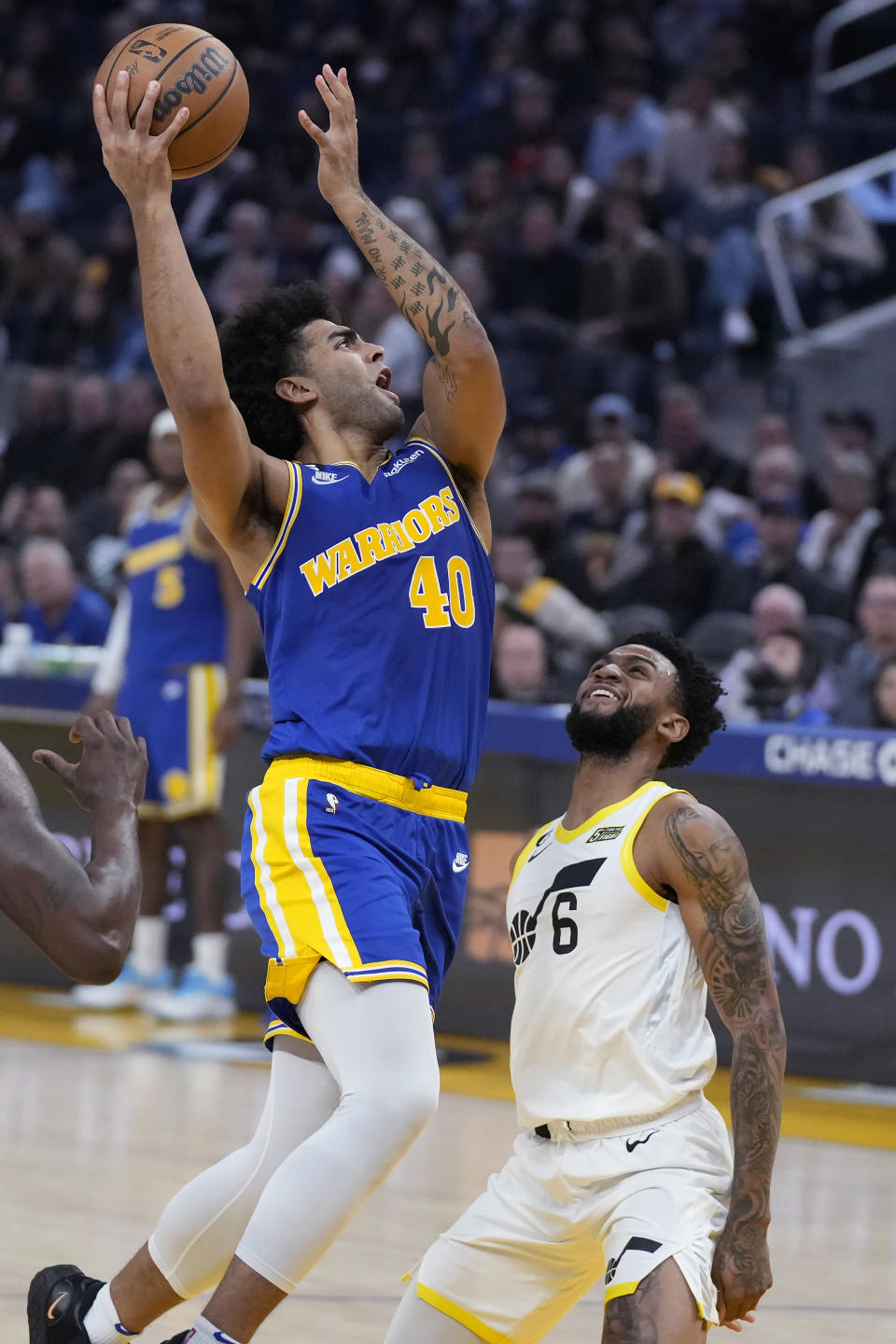 Golden State Warriors forward Anthony Lamb (40) shoots over Utah Jazz guard Nickeil Alexander-Walker (6) during the first half of an NBA basketball game in San Francisco, Wednesday, Dec. 28, 2022. (AP Photo/Jeff Chiu)