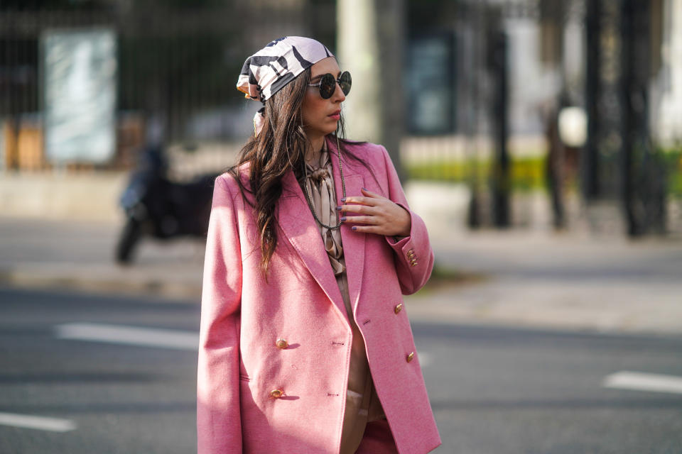 PARIS, FRANCE - FEBRUARY 23: Gabriella Berdugo wears a pink oversized suit, flare pants and silky blouse from Paul and Joe, a pink head scarf from Dior, sunglasses with a chain from Chanel, on February 23, 2021 in Paris, France. (Photo by Edward Berthelot/Getty Images)