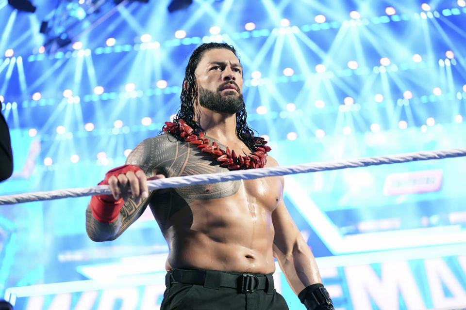 Roman Reigns enters the ring to face Brock Lesnar during WrestleMania 38 in Arlington Texas, April 3, 2022. Reigns and Cody Rhodes will be in the main event of WrestleMania 39 on April 2, 2023, in Los Angeles. (WWE via AP)