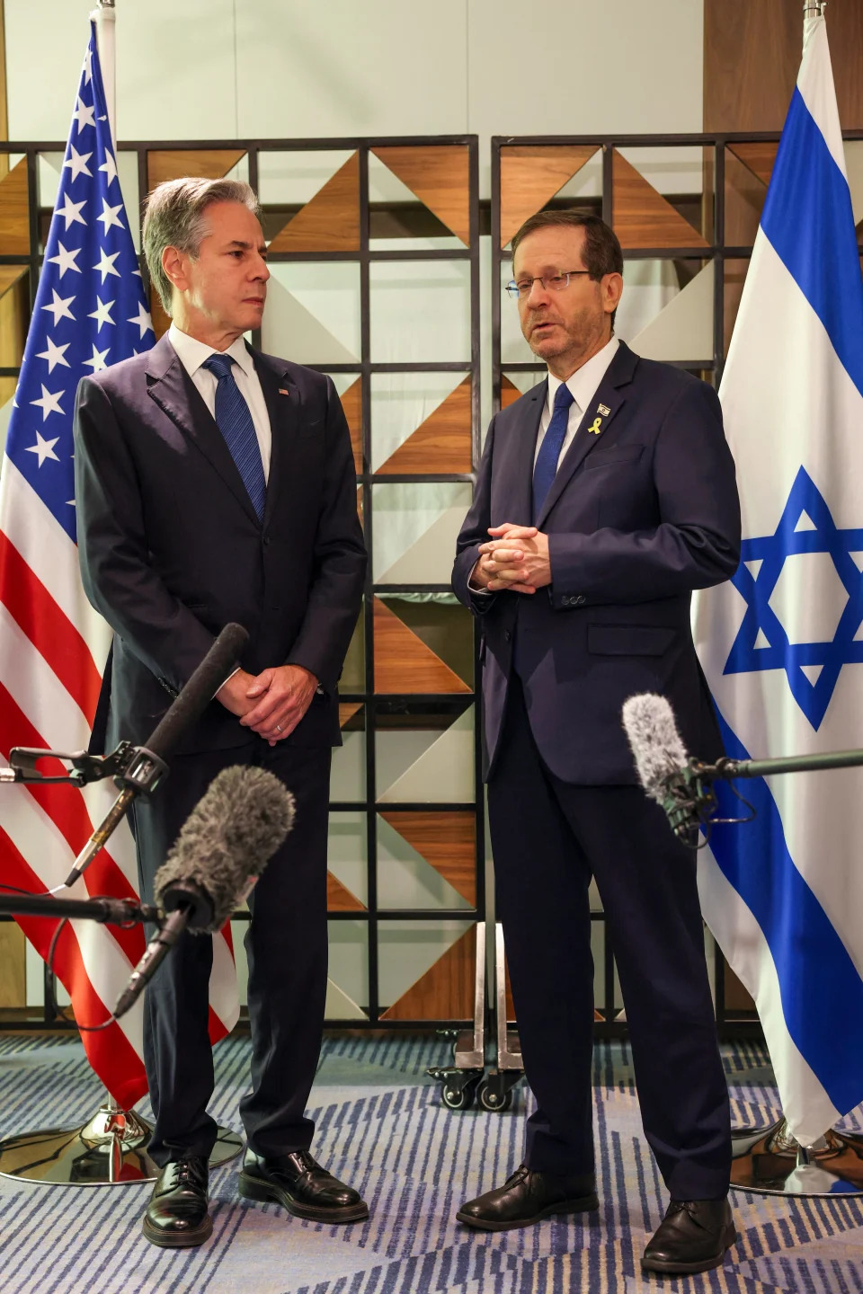 Secretary of State Antony Blinken stands with Israeli President Isaac Herzog ahead of their meeting in Tel Aviv on Aug. 19, 2024.