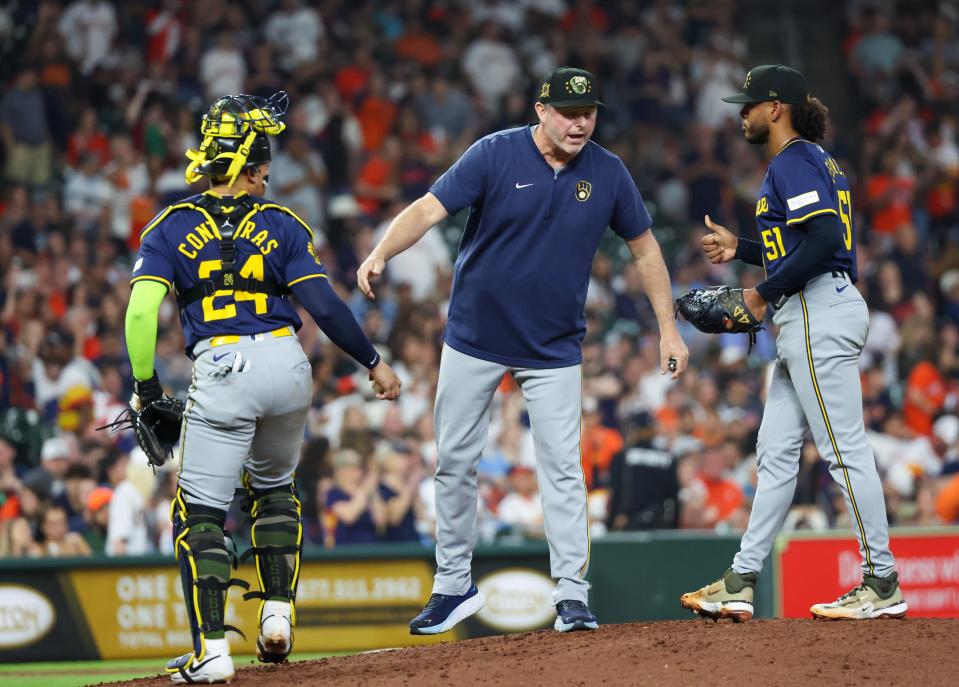 May 17, 2024; Houston, Texas, USA; Milwaukee Brewers pitching coach Chris Hook (84) talks with catcher William Contreras (24) and starting pitcher Freddy Peralta (51) before pitching against Houston Astros in the fifth inning at Minute Maid Park. Mandatory Credit: Thomas Shea-USA TODAY Sports
