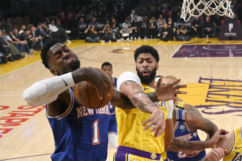 New York Knicks forward Bobby Portis, left, and Los Angeles Lakers forward Anthony Davis reach for a rebound during the first half of an NBA basketball game Tuesday, Jan. 7, 2020, in Los Angeles. (AP Photo/Mark J. Terrill)