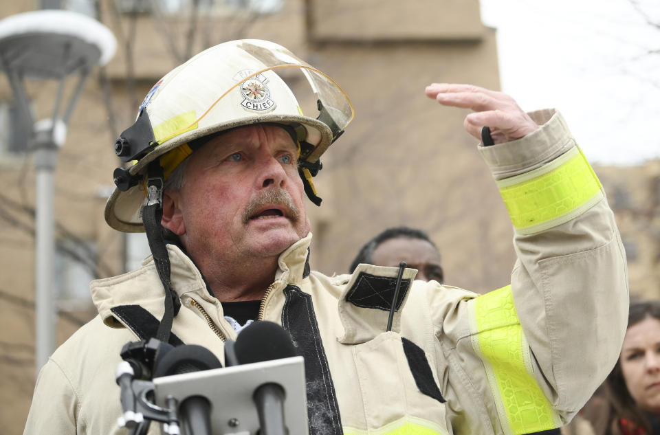 Minneapolis Fire Department Chief John Fruetel speaks to the media in front of the building at 630 Cedar Avenue where an early morning fire killed multiple people Wednesday, Nov. 27, 2019 in Minneapolis. Residents of the high rise were evacuated early Wednesday after a fire broke out on the 14th floor of the building. (Aaron Lavinsky/Star Tribune via AP)