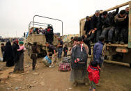 Displaced Iraqi people who fled their homes during a battle between Iraqi forces and Islamic State militants, arrive at a checkpoint to be transfer to Hammam al-Alil camp, in Mosul, Iraq, March 20, 2017. REUTERS/Thaier Al-Sudani