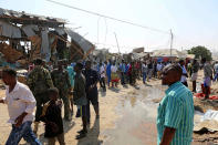 <p>People gather at site after a bomb-laden vehicle attacked a marketplace in Moghadishu, Somalia on Feb. 19, 2017. (Photo: Sadak Mohamed/Anadolu Agency/Getty Images) </p>