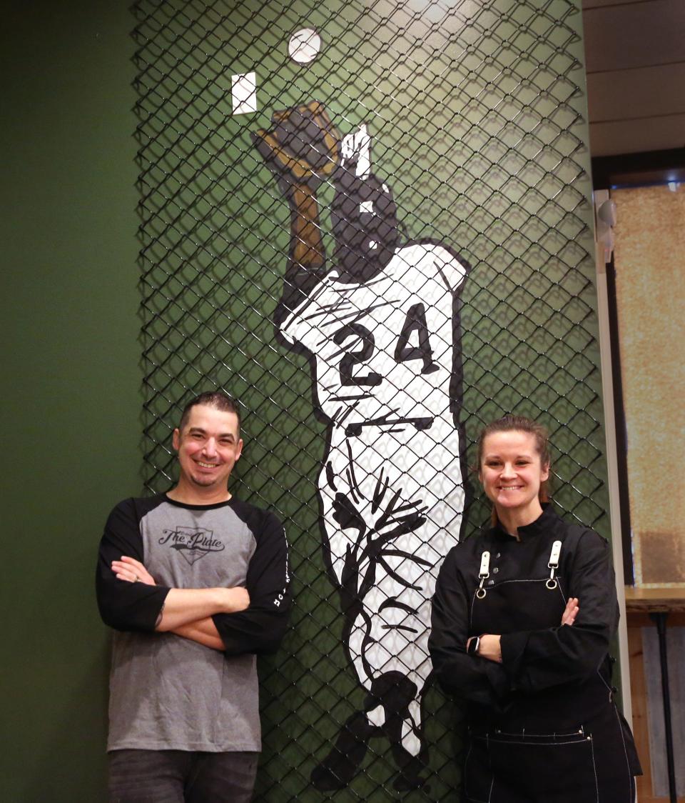 John and Martha Edwards are decorating Behind the Plate, their baseball-themed restaurant in Portsmouth, with artwork that includes New York Giants center fielder Willie Mays' famous catch Game 1 of the World Series on Sept. 29, 1954.