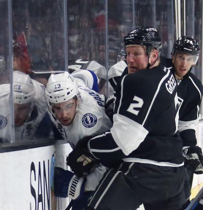 LOS ANGELES, CA - FEBRUARY 16: Matt Greene #2 of the Los Angeles Kings checks Cedric Paquette #13 of the Tampa Bay Lightning against the boards during the first period at the Staples Center on February 16, 2015 in Los Angeles, California.  (Photo by Bruce Bennett/Getty Images)