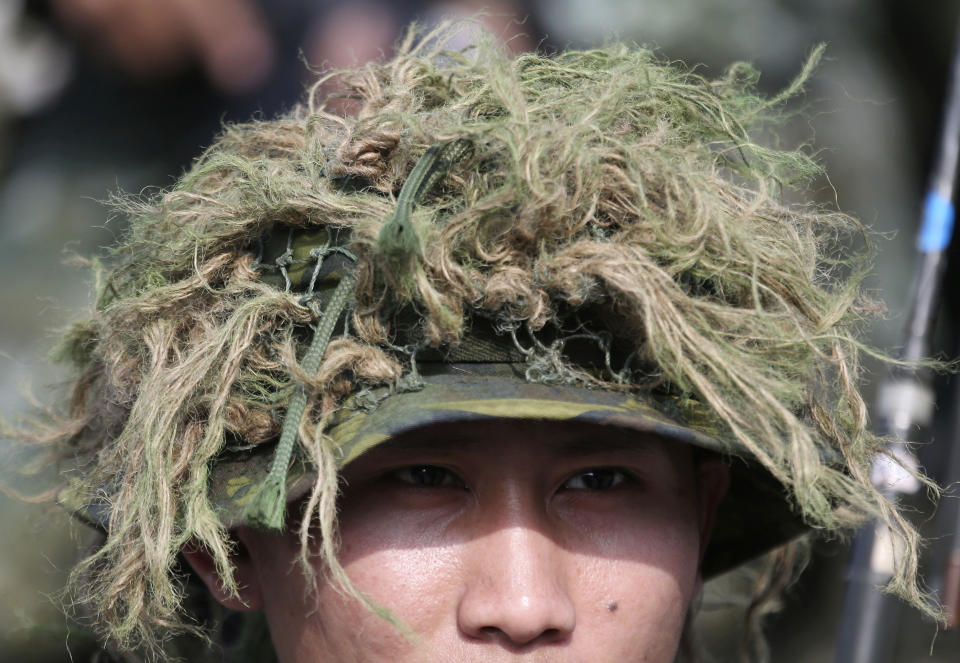 A sniper wears camouflage during a military exercise in Kaohsiung, southern Taiwan, Wednesday, Jan. 15, 2020. Taiwan military started a two-day joint forces exercises on Wednesday to show its determination to defend itself from Chinese threats. (AP Photo/Chiang Ying-ying)