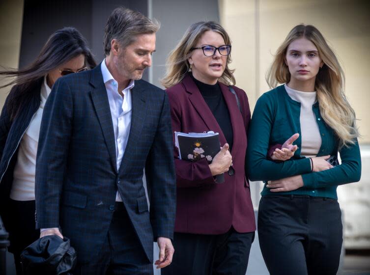 VAN NUYS, CA - FEBRUARY 14: Rebecca Grossman, second from left, with her husband, Dr. Peter Grossman, left, and daughter heads to Van Nuys Courthouse West Van Nuys, CA. (Irfan Khan / Los Angeles Times)