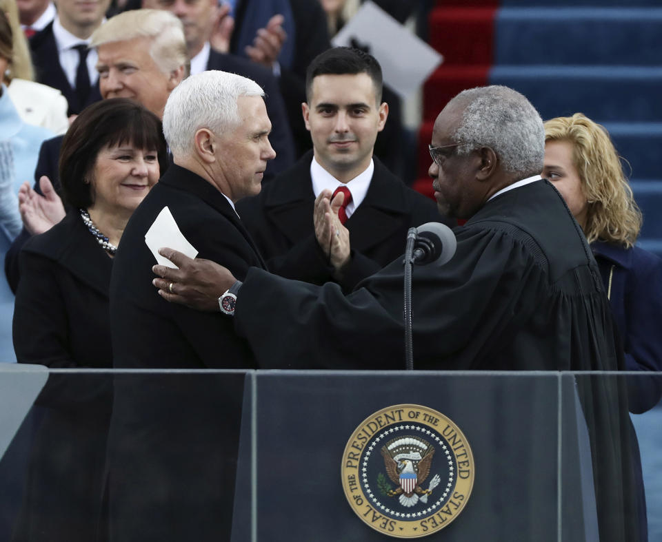 <p>Vice President Mike Pence (L) shakes hands with Justice Clarence Thomas (R) after being sworn in during inauguration ceremonies swearing in Donald Trump as the 45th president of the United States on the West front of the U.S. Capitol in Washington on Jan. 20, 2017. (Photo: Carlos Barria/Reuters) </p>