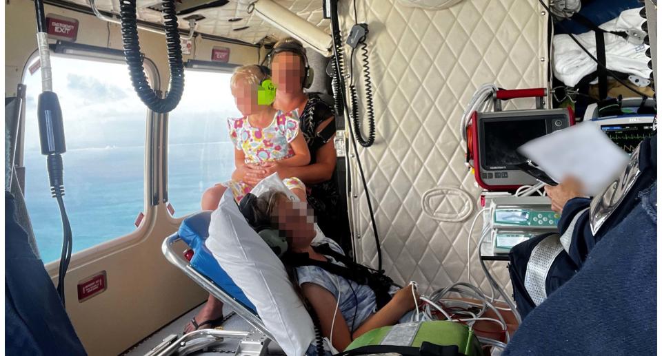 A little girl, with her mother and another little girl, in the RACQ LifeFlight rescue chopper.