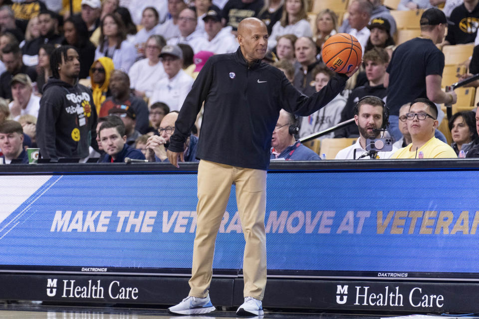 Mississippi head coach Win Case catches the ball as it goes out of bounds during the second half of an NCAA college basketball game against Missouri Saturday, March 4, 2023, in Columbia, Mo. Missouri won 82-77. (AP Photo/L.G. Patterson)