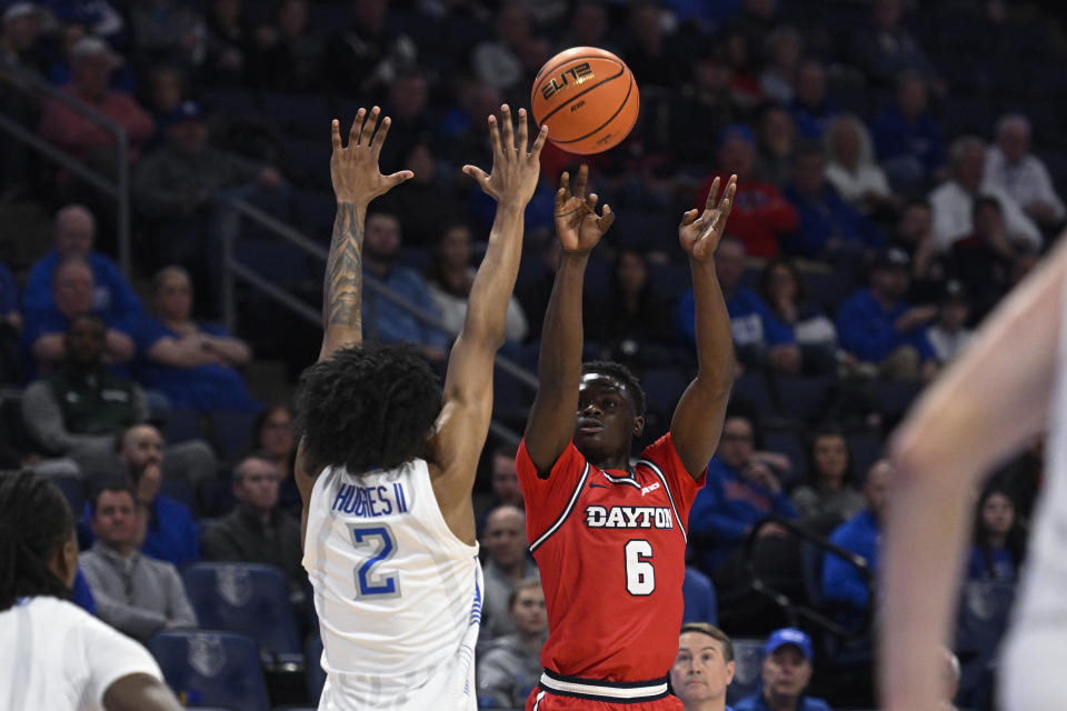 Dayton's Enoch Cheeks, right, goes up for a shot against Saint Louis' Larry Hughes II during the first half of an NCAA college basketball game Tuesday, March 5, 2024, in St. Louis. (AP Photo/Joe Puetz)