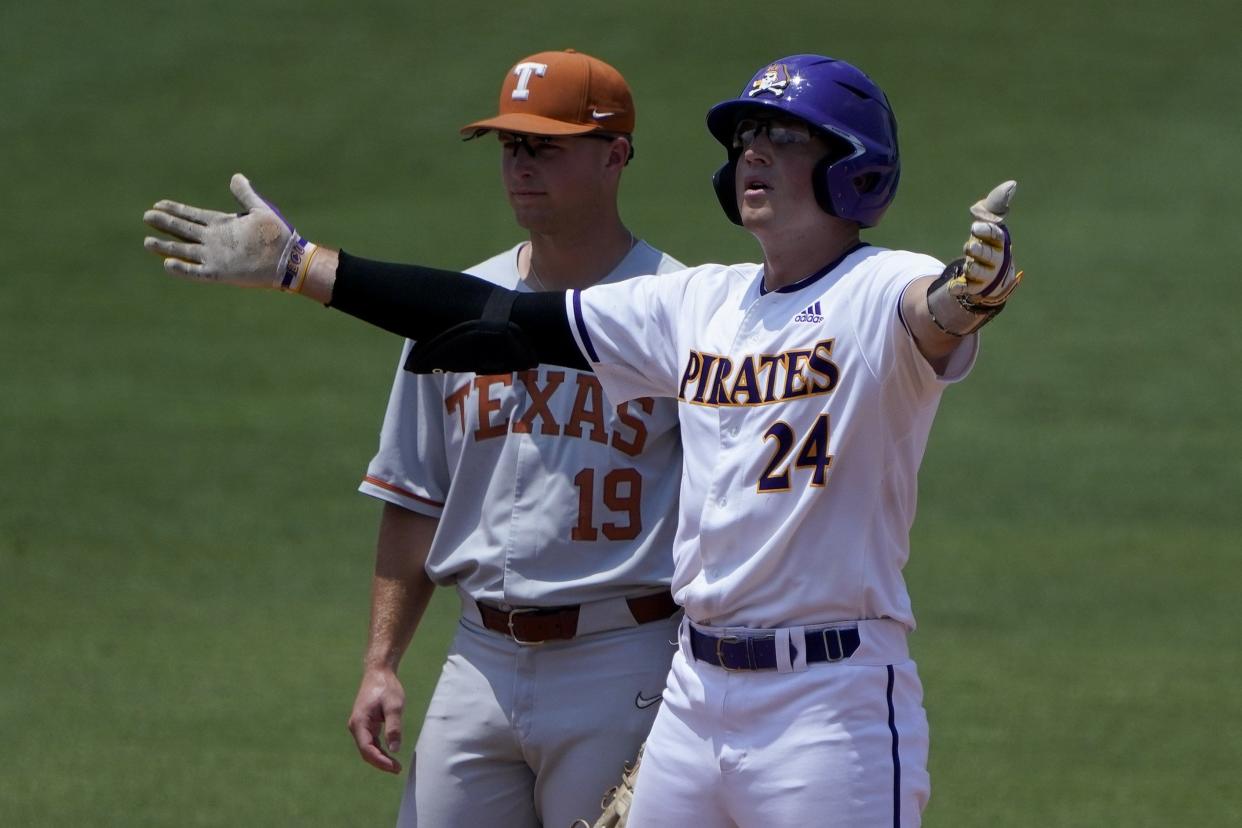 East Carolina's Ben Newton celebrates after hitting a double as Texas infielder Mitchell Daly looks on during the fourth inning of Friday's 13-7 Pirates victory in Game 1 of their best-of-three super regional series. The Longhorns must now sweep ECU on Saturday and Sunday to extend their season.