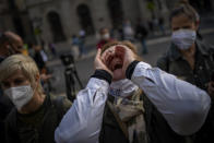 Health workers protest in front of the Palace of the Generalitat, the headquarter of the Government of Catalonia, during a protest against their working conditions in Barcelona, Spain, Thursday, Oct. 29, 2020. As more of Spain's regions apply border transit restrictions, the government is seeking parliamentary approval to extend the country's newly declared state of emergency to rein in the resurging coronavirus pandemic until May, a proposal that is rejected by some opposition parties. (AP Photo/Emilio Morenatti)