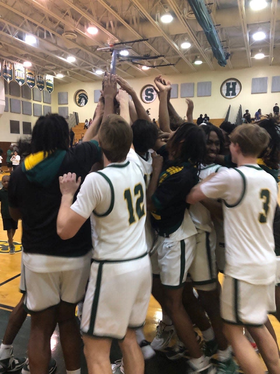 Suncoast players celebrate on the court moments after beating Fort Lauderdale-Stranahan 72-55 to win the District 14-5A title Friday night in Riviera Beach.