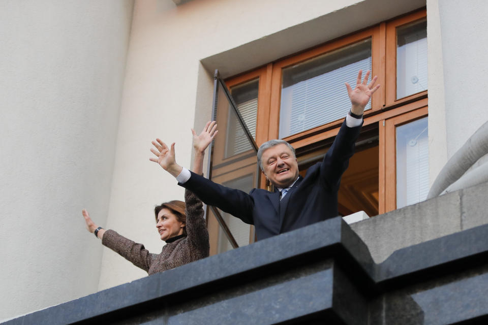 Ukrainian President Petro Poroshenko and his wife Maryna gesture as they greet their supporters who have come to thank him for what he did as a president, in Kiev, Ukraine, Monday, April 22, 2019. Political mandates don't get much more powerful than the one Ukrainian voters gave comedian Volodymyr Zelenskiy, who as president-elect faces daunting challenges along with an overwhelming directive to produce change. (AP Photo/Vadim Ghirda)