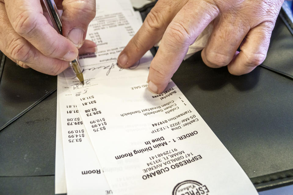 Coral Gables, Florida, pedestrian plaza and restaurant row, Espresso Cubano, signing credit card receipt. (Photo by: Jeffrey Greenberg/UCG/Universal Images Group via Getty Images)