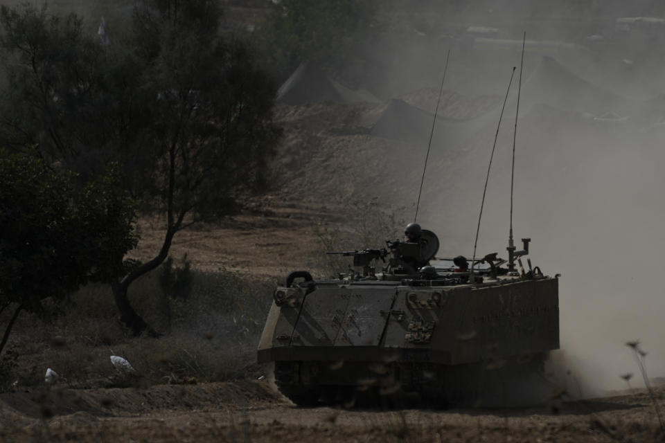 Israeli armored personnel carrier moves near the border with Gaza Strip on Tuesday, Oct. 31, 2023. Over the past five days, Israeli ground troops have pushed deeper and deeper into Gaza in their war against Hamas, launched in response to a bloody Oct. 7 cross-border raid by the Islamic militant group. Yet even as the operation expands each day, the army refuses to call it an invasion. Its vague choice of words appears to be a deliberate strategy aimed at keeping its enemy off balance and preserving its options as a lengthy war unfolds. (AP Photo/Ariel Schalit)