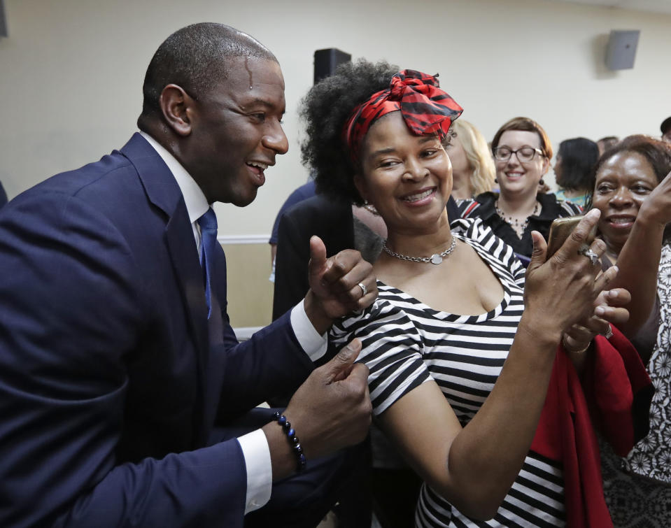 Florida Democratic gubernatorial candidate Andrew Gillum, left, poses for a photo with supporter Cynthia Harris at a Democratic Party rally Friday, Aug. 31, 2018, in Orlando, Fla. Gillum's matchup against the Republican nominee, U.S. Rep. Ron DeSantis, and Sen. Bill Nelson's race against Republican Gov. Rick Scott are two of the most-watched races in the midterm elections. (AP Photo/John Raoux)