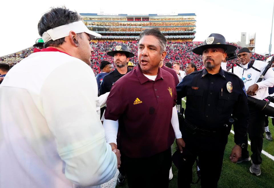 Nov 25, 2022; Tucson, AZ, USA;  Arizona Wildcats head coach Jedd Fisch shakes hands with Arizona State Sun Devils head coach Shaun Aguano after the Wildcats won 38-35 during the Territorial Cup game at Arizona Stadium.
