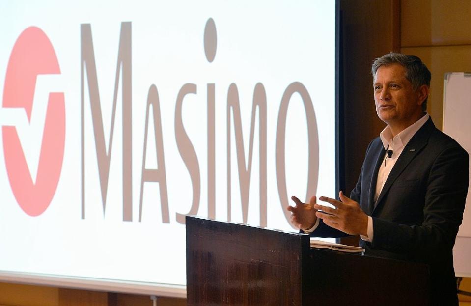 joe kiani giving a speech in front of a masimo logo