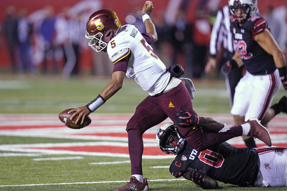 Utah linebacker Devin Lloyd, right, tackles Arizona State quarterback Jayden Daniels (5) during the second half of an NCAA college football game Saturday, Oct. 16, 2021, in Salt Lake City. (AP Photo/Rick Bowmer)