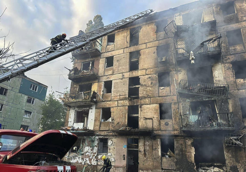 In this photo released by Dnipro Regional Administration, emergency workers extinguish a fire after missiles hit a multi-story apartment building in Kryvyi Rih, Ukraine, Tuesday, June 13, 2023. (Dnipro Regional Administration via AP)