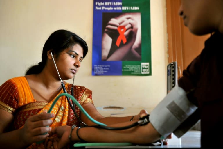 A nurse carries out tests on an HIV-positive patient in Bangalore