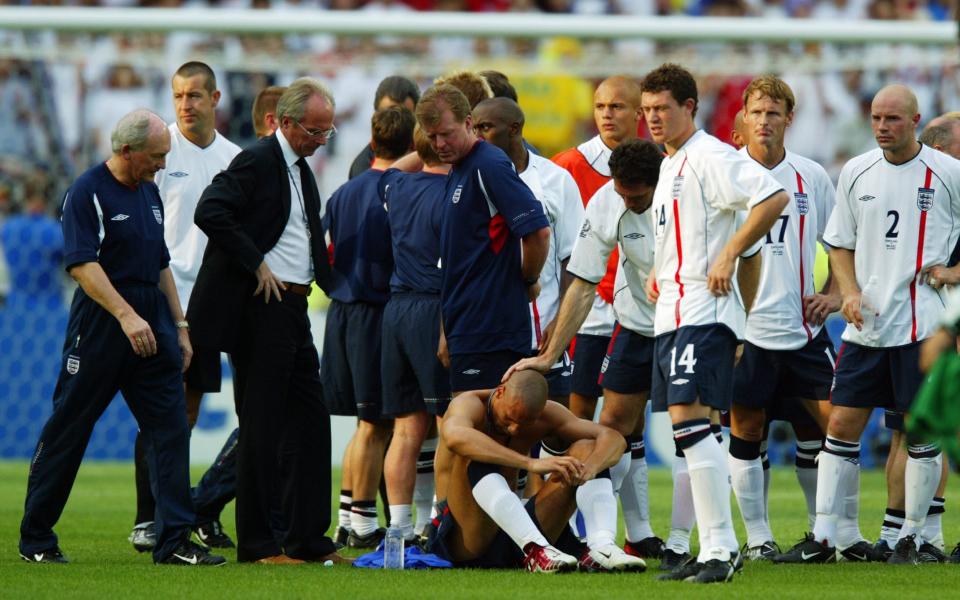 Martin Keown consoles Rio Ferdinand after England are beaten by Brazil in the 2002 World Cup quarter-finals - GETTY IMAGES