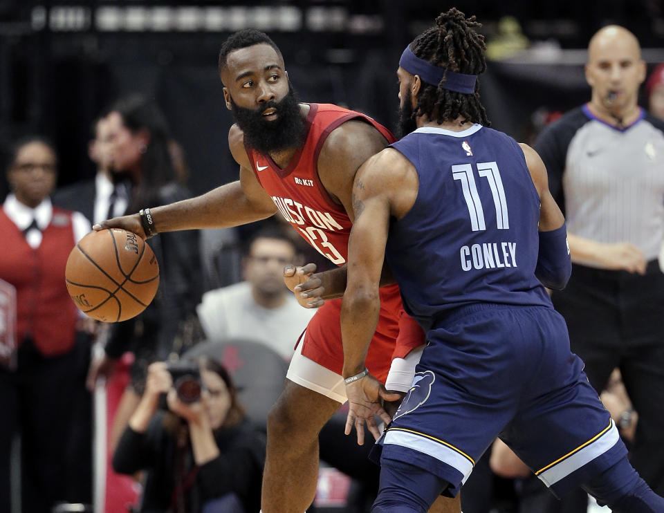 Houston Rockets guard James Harden (13) looks to pass the ball under pressure from Memphis Grizzlies guard Mike Conley (11) during the first half of an NBA basketball game Monday, Dec. 31, 2018, in Houston. (AP Photo/Michael Wyke)