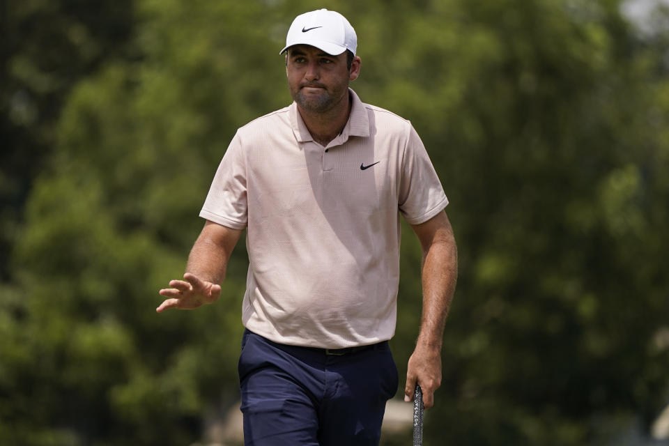 Scottie Scheffler reacts to his putt on the first green during the third round of the Tour Championship golf tournament, Sunday, Aug. 27, 2023, in Atlanta. (AP Photo/Mike Stewart)