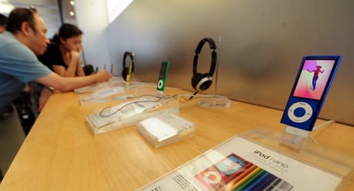 This file photo shows customers checking out the products at an Apple shop in Beijing. Apple reported blockbuster quarterly earnings last month with net profit more than doubling to a record $13.06 billion and revenue soaring to an all-time high of $46.33 billion