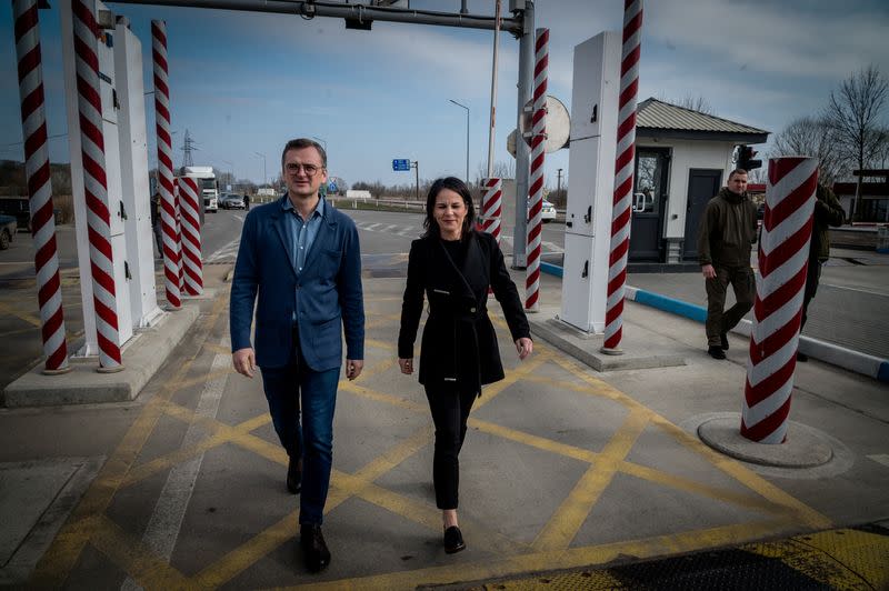 Germany's FM Baerbock and Ukrainian counterpart Kuleba walk at a Ukraine-Moldova border crossing point in Odesa region