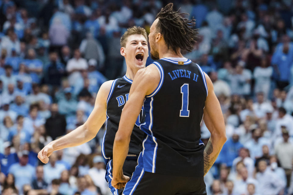 Duke center Kyle Filipowski, rear, celebrates with center Dereck Lively II (1) during the second half of the team's NCAA college basketball game against North Carolina on Saturday, March 4, 2023, in Chapel Hill, N.C. (AP Photo/Jacob Kupferman)