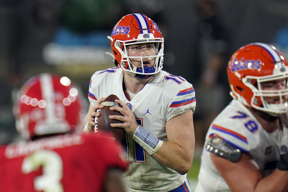 Florida quarterback Kyle Trask (11) looks for a receiver during the second half of the team's NCAA college football game against Georgia, Saturday, Nov. 7, 2020, in Jacksonville, Fla. (AP Photo/John Raoux)