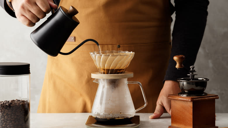 person making pour over coffee
