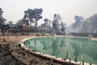 A burnt camping during a wildfire in Agia Anna village on the island of Evia, about 146 kilometers (91 miles) north of Athens, Greece, Friday, Aug. 6, 2021. Thousands of people fled wildfires burning out of control in Greece and Turkey on Friday, including a major blaze just north of the Greek capital of Athens that claimed one life, as a protracted heat wave left forests tinder-dry and flames threatened populated areas and electricity installations. (AP Photo/Thodoris Nikolaou)