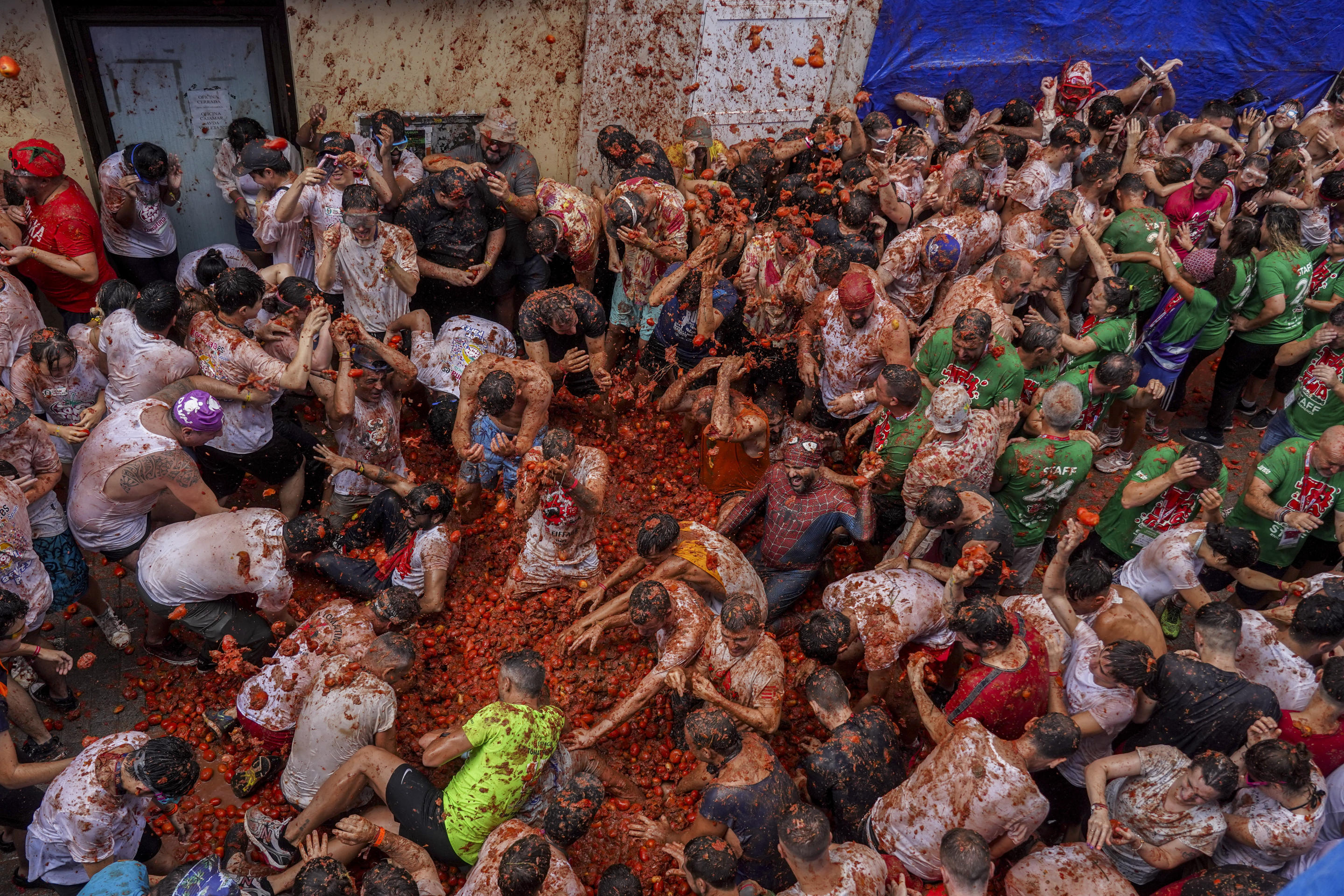 Revelers throw tomatoes at each other during the annual Tomatina tomato fight in the village of Bunol near Valencia, Spain on Wednesday.