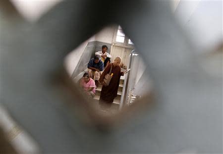 A Buddhist nun is pictured in the Muslim Charity Hospital in Yangon November 1, 2013. Myanmar's reformist government is seeking foreign investment to revive one of Asia's sickest healthcare systems. REUTERS/Soe Zeya Tun